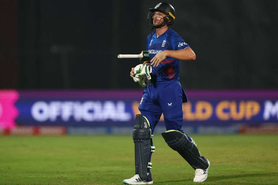 England's Jos Buttler walks after losing his wicket, bowled out by Afghanistan's Naveen-Ul-Haq