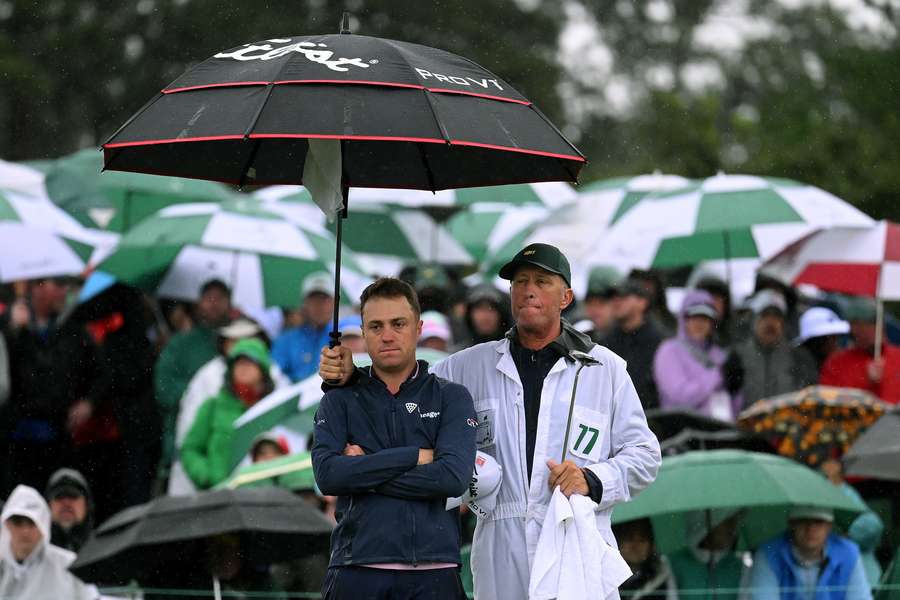 Justin Thomas and his caddie Jim 'Bones' Mackay react to his bogey on the 18th green