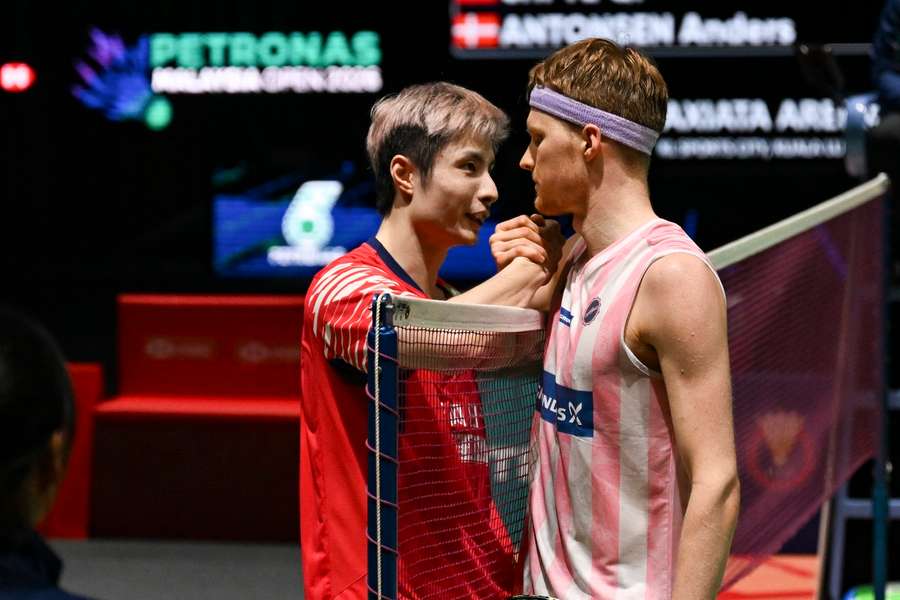 China's Shi Yuqi shakes hands with Anders Antonsen after the men's singles semifinal match at the Malaysia Open