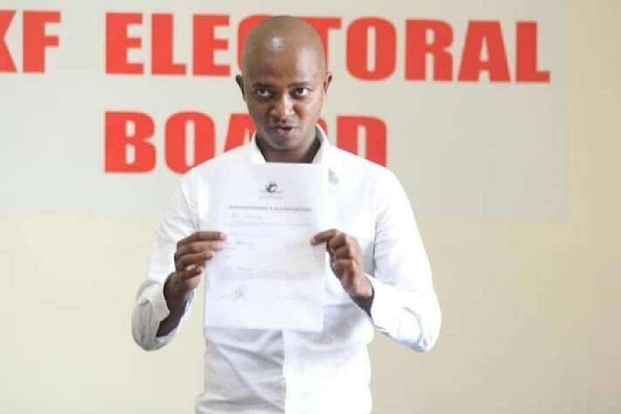 Mwendwa displaying his nomination certificate during the last election