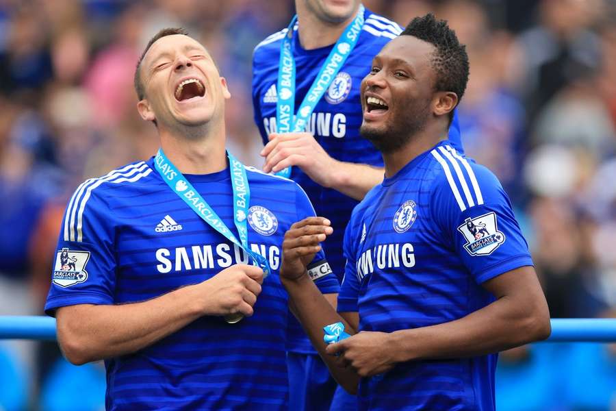 Former Chelsea star Mikel John Obi (right) has announced his retirement from football, aged 35