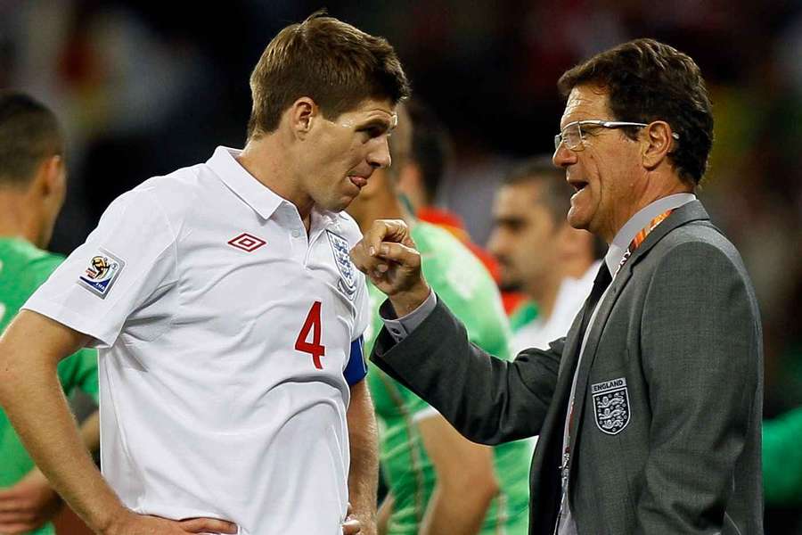 Fabio Capello speaks to Steven Gerrard during England's 2010 World Cup match against Algeria