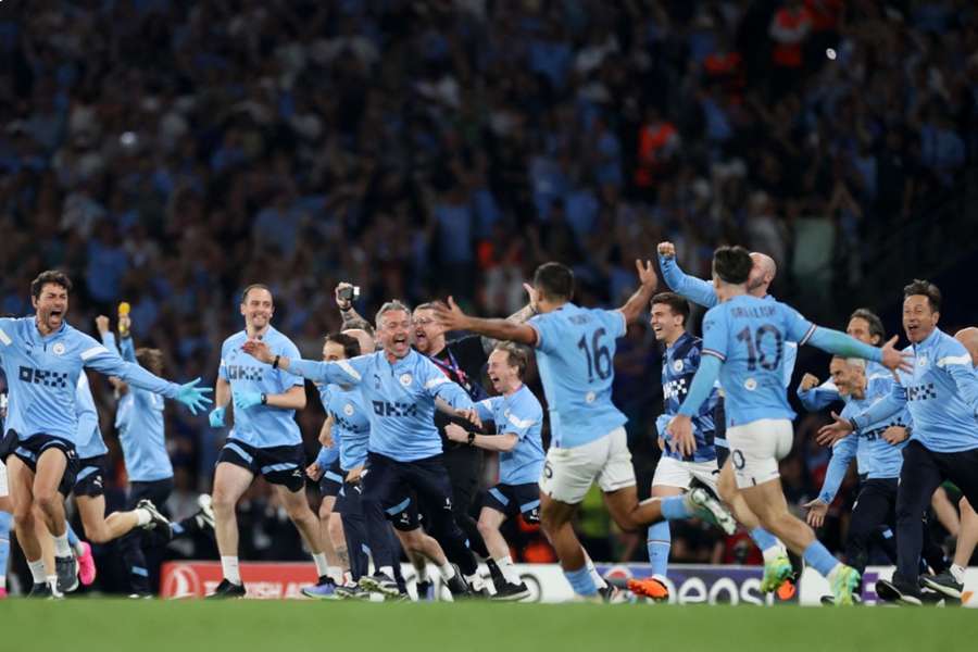 Manchester City players and staff celebrate after the final whistle