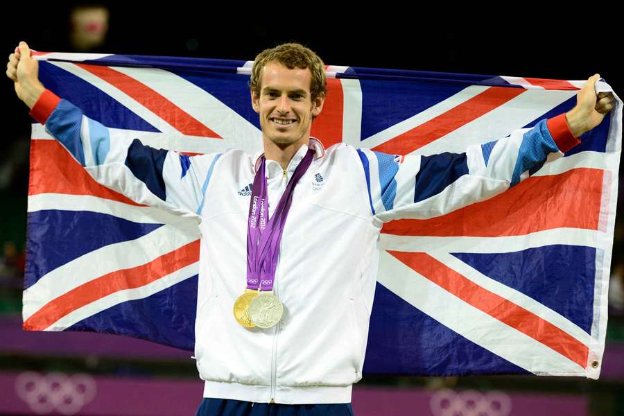 Great Britain's Andy Murray poses with his gold medal won in the men's single tournament