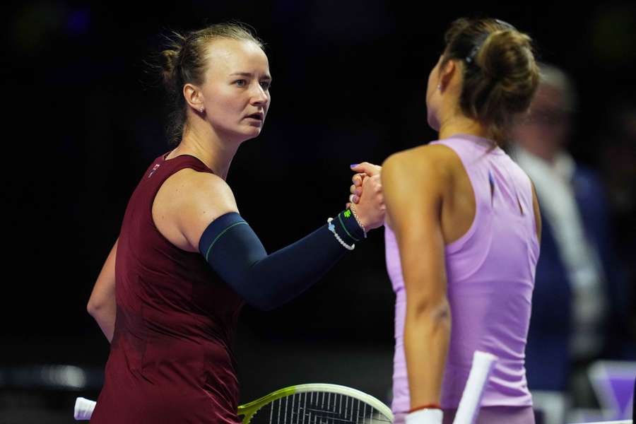 Barbora Krejcikova shakes hands with Zheng Qinwen after losing her women's singles semi-final at the WTA Finals