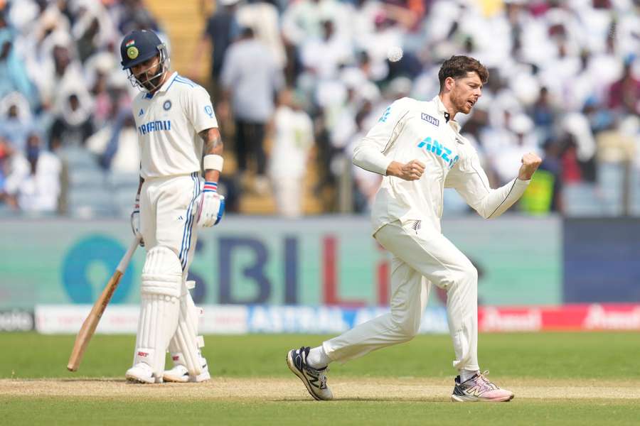 New Zealand's Mitchell Santner celebrates the wicket of Virat Kohli