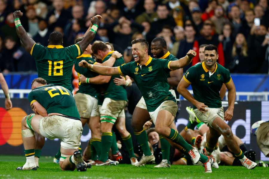 South Africa's Handre Pollard and Damian de Allende celebrate with teammates after winning the world cup final