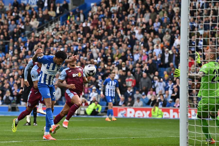 Brighton's Brazilian striker #09 Joao Pedro (L) heads home the rebound after Aston Villa's Swedish goalkeeper #25 Robin Olsen saves his penalty