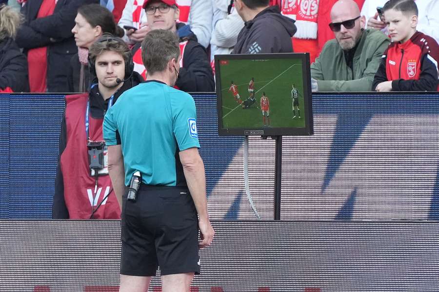A German referee checks a decision A German referee checks a decision