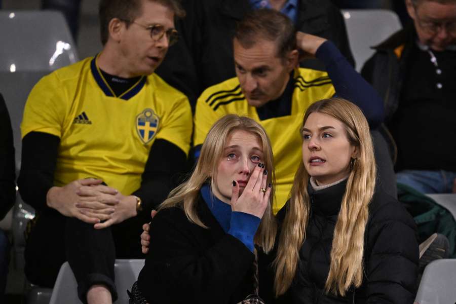 Swedish supporters react as they wait in the stand during the Euro 2024 qualifying football match between Belgium and Sweden