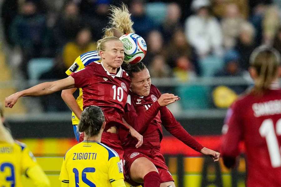 Denmark's Pernille Harder and Cecilie Flře in a head-to-head battle with Sweden's Elma Junttila Nelhage during Tuesday's clash