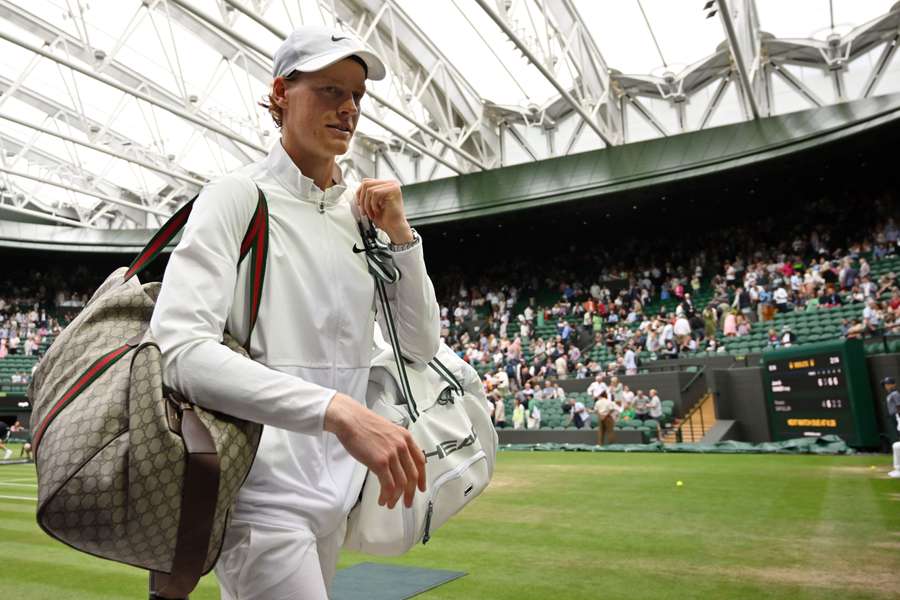 Jannik Sinner leaves the court after beating Roman Safiullin to reach the Wimbledon semi-final