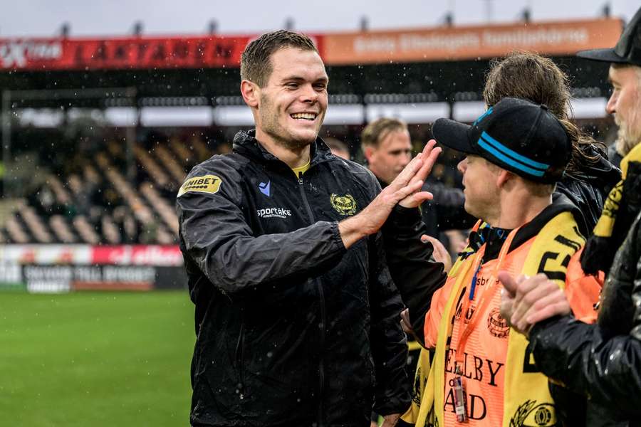Jacob Bergstrom celebrates with Mjallby fans after the match