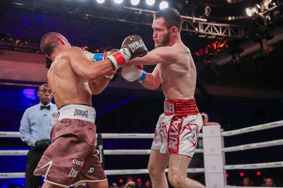 Murtazaliev (R) lands a big punch on Tszyu