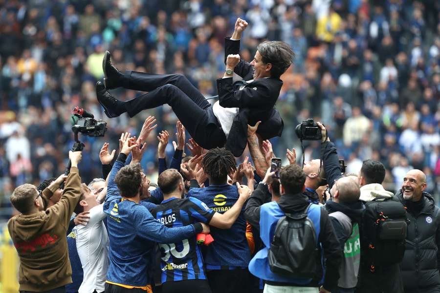 Simone Inzaghi celebrates with his players after the team were confirmed as champions of Serie A 