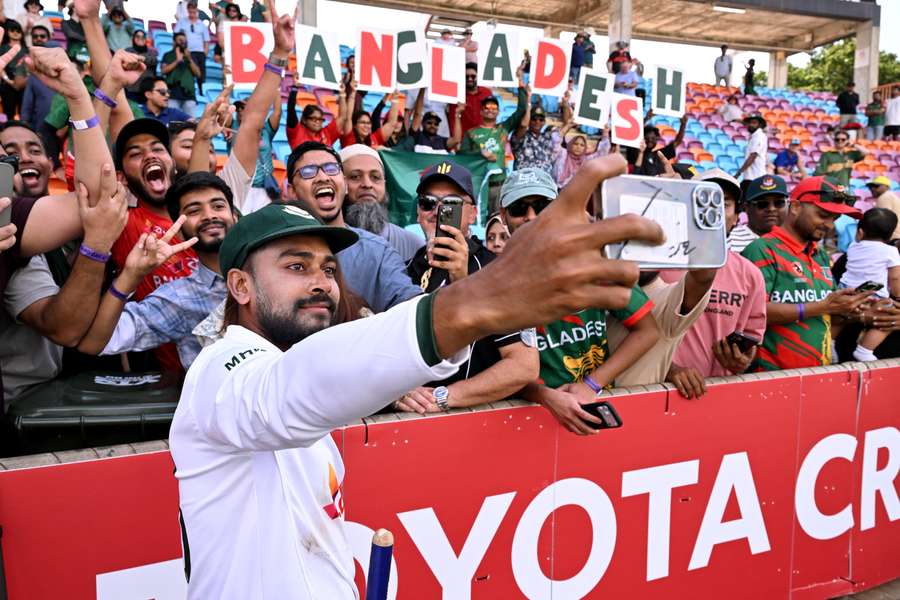 Bangladesh's Mehidy Hasan Miraz celebrates with fans after making history