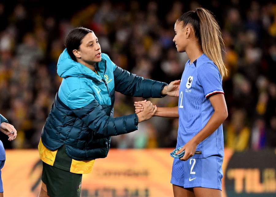 Kerr (L) shakes hands with France's Maëlle Lakrar