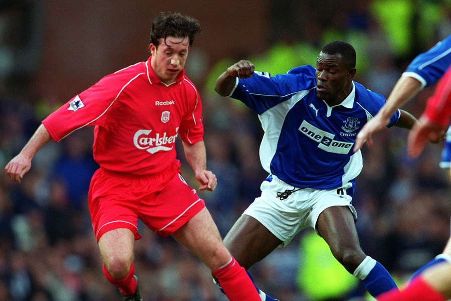 Robbie Fowler and Alex Nyarko battle for the ball