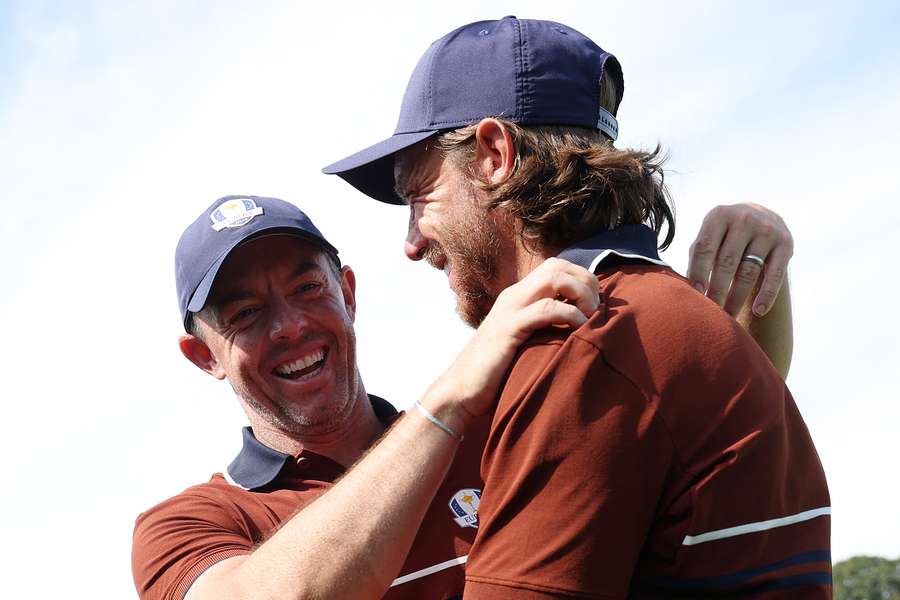 Rory McIlroy and Tommy Fleetwood react after defeating Harris English and Collin Morikawa 3&2 in the morning foursomes