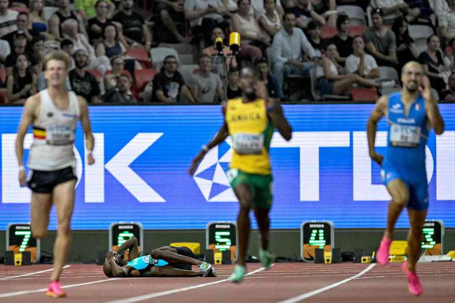 Steven Gardiner lies on the track in the men's 400m semi-final