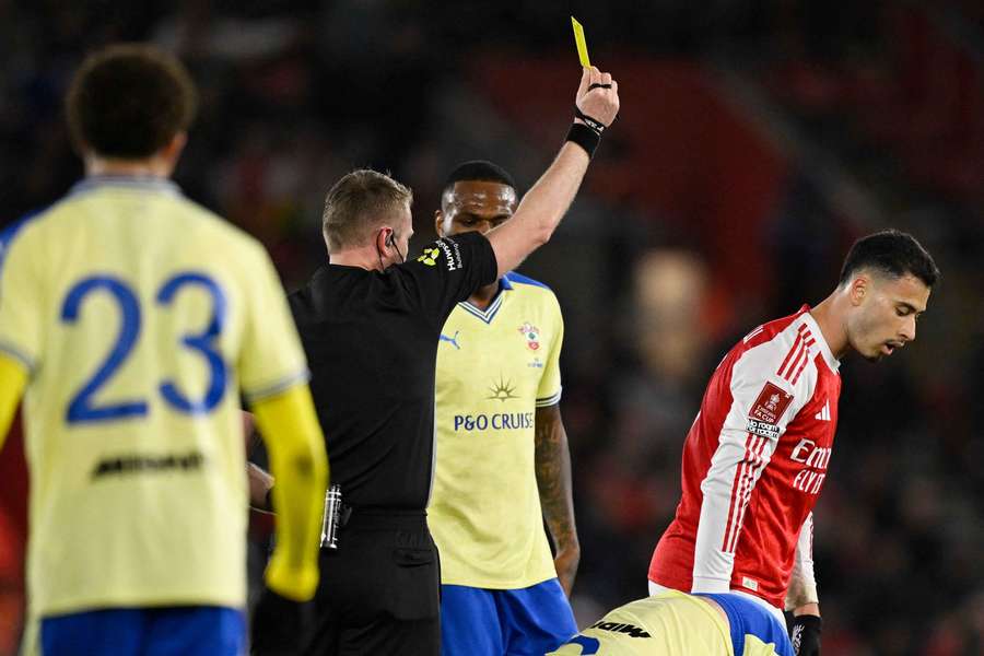 Arsenal's Gabriel Martinelli (right) is shown a yellow card by referee Samuel Barrott Arsenal's Gabriel Martinelli (right) is shown a yellow card by referee Samuel Barrott