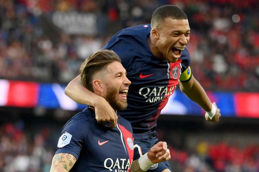 Paris Saint-Germain defender Sergio Ramos (L) celebrates scoring his team's first goal with forward Kylian Mbappe