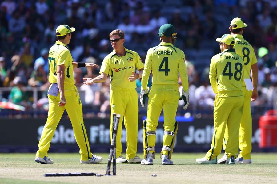 Australia's Adam Zampa celebrates with teammates after taking the wicket of South Africa's Keshav Maharaj 