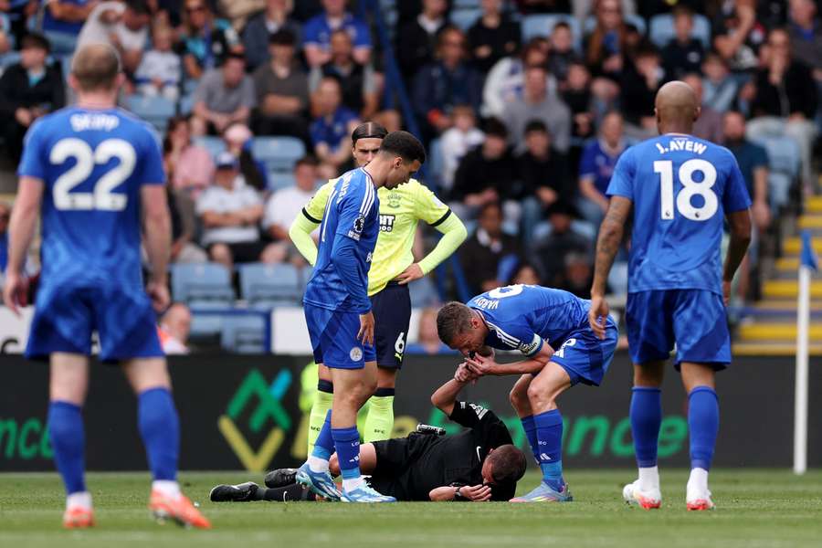Jamie Vardy blows referee David Webb's whistle, who fell to the floor with concussion