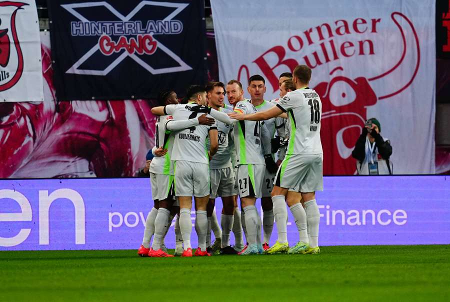 Wolfsburg's players celebrate their first goal