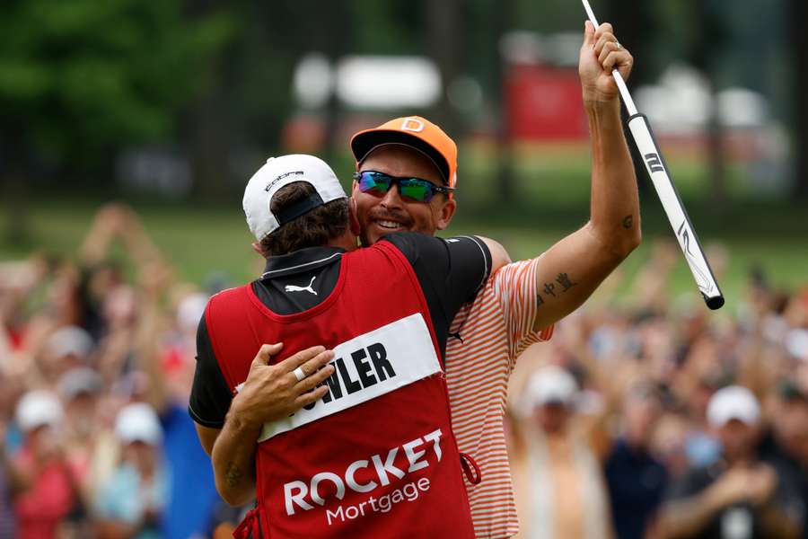 Rickie Fowler of the United States and his caddie Ricky Romano celebrate