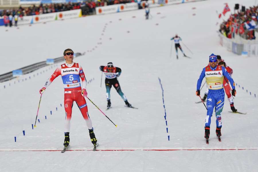 Winner Johannes Hoesfolt Klaebo of Norway (L) and second placed Federico Pellegrino of Italy (R) in action