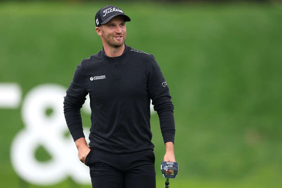 Wyndham Clark of the United States acknowledges the crowd after making the course record low score of 60 at the Pebble Beach Pro-Am on Saturday