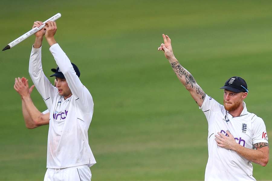 England's captain Ben Stokes (R) and his teammates celebrate after winning the first Test cricket match between India and England