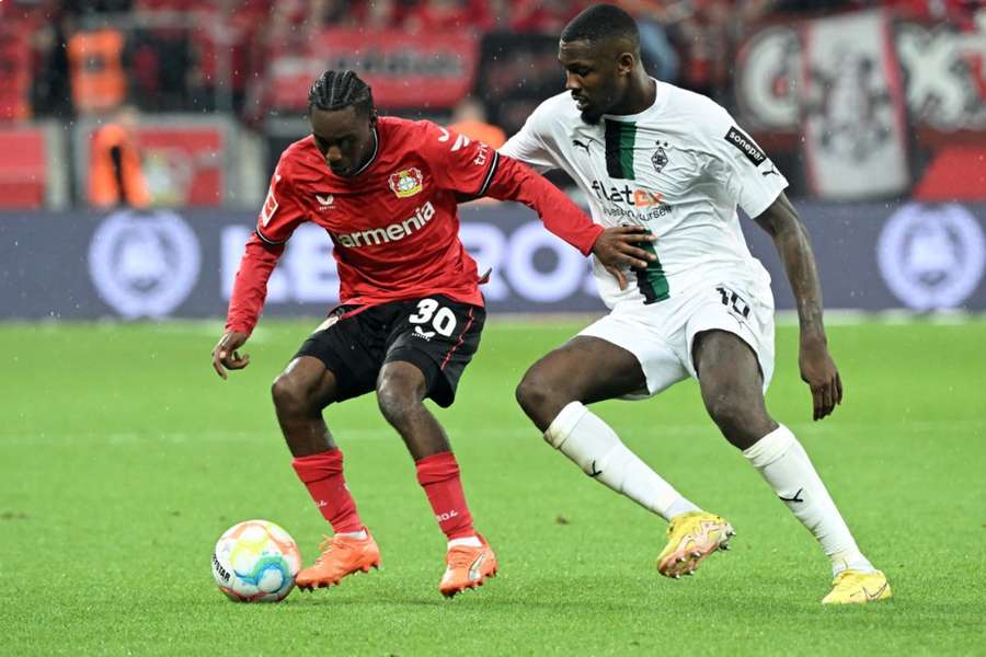 Jeremie Frimpong and Marcus Thuram do battle for the ball