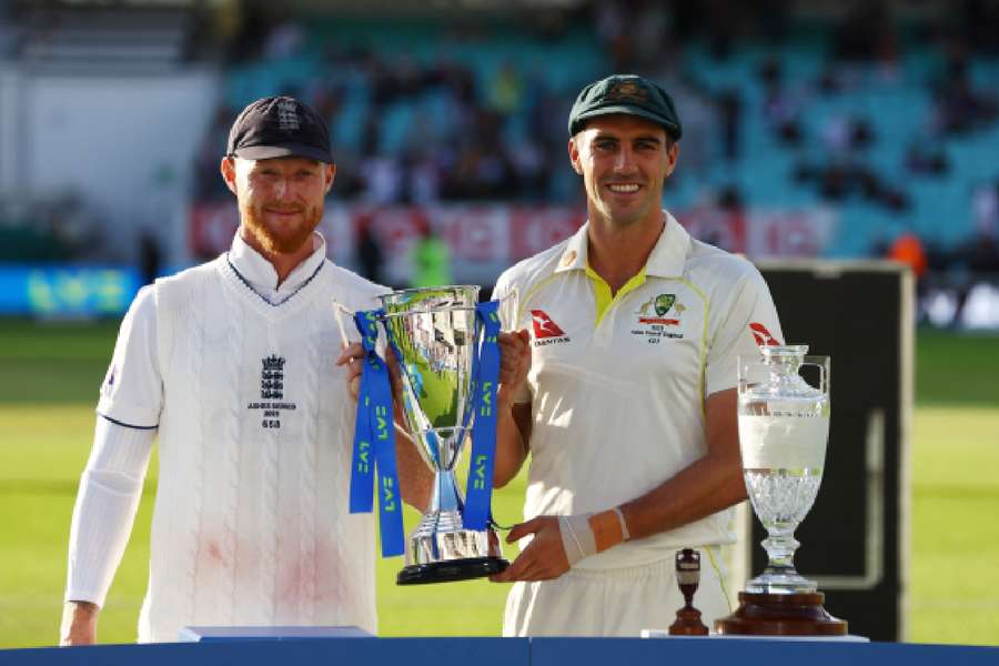Stokes and Cummins pose with the trophy after the drawn series