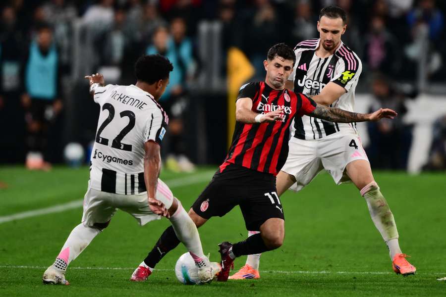 AC Milan's Christian Pulisic fights for the ball with Juventus' Weston McKennie and Federico Gatti