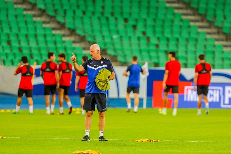 Iraq head coach Graham Arnold oversees a practice session at Basra International Stadium.