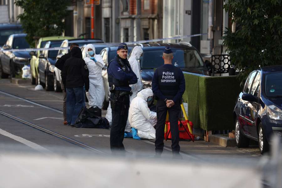 Police officers work outside the site of a police operation against a deadly shooting suspect