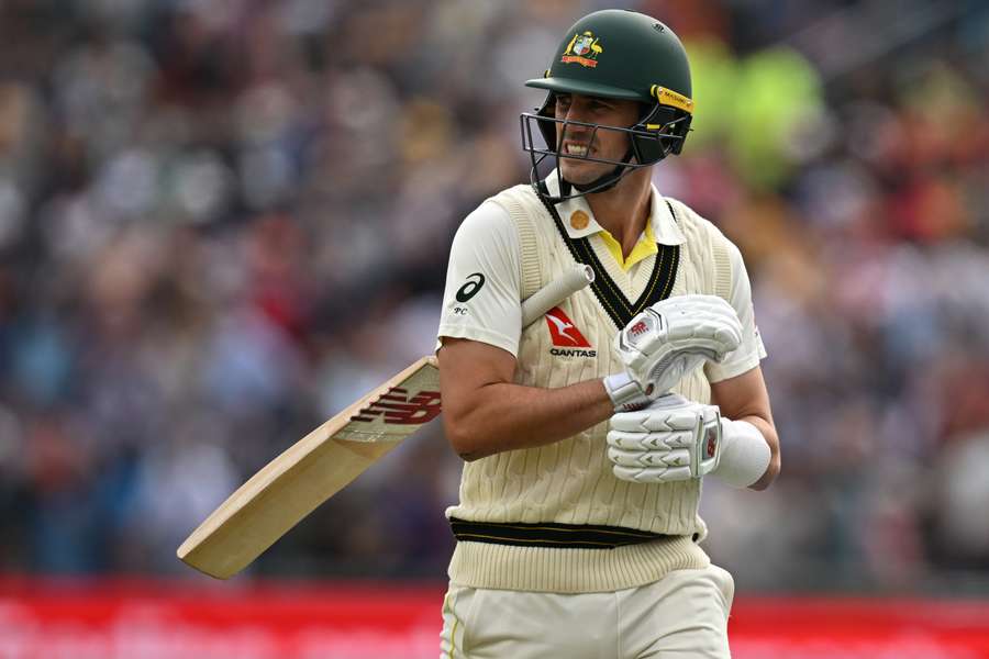 Australia's Pat Cummins reacts as he walks back to the pavilion after losing his wicket without scoring