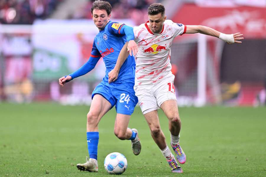 Christoph Baumgartner, right, and Magnus Knudsen battle for the ball
