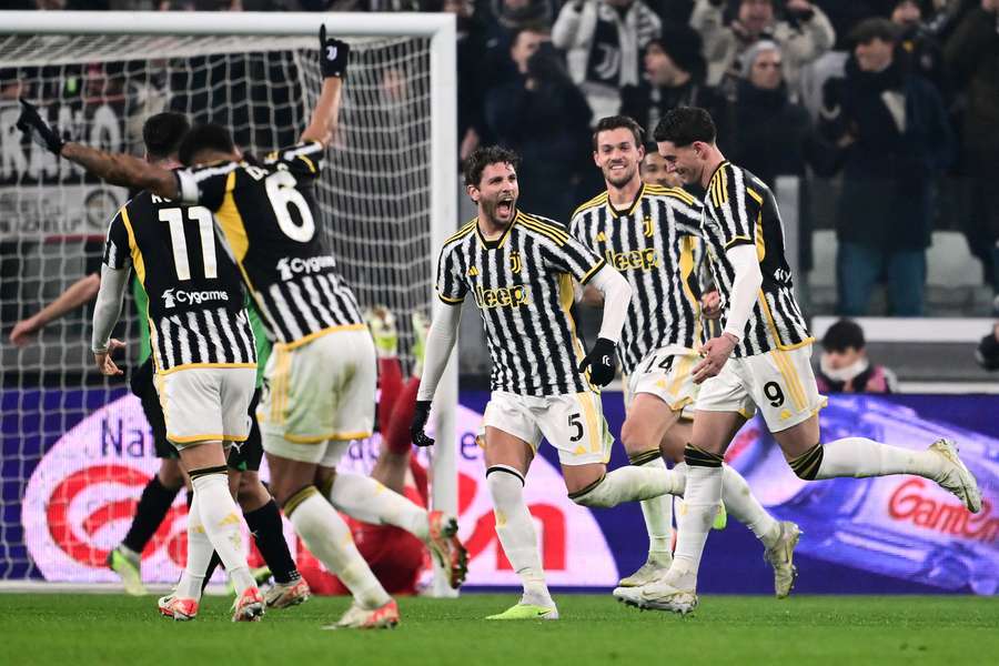 Juventus forward Dusan Vlahovic (R) celebrates with teammates after scoring