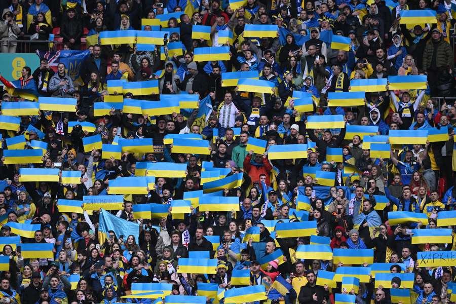 Ukraine supporters hold up flags ahead of the Euro 2024 qualifier against England at Wembley