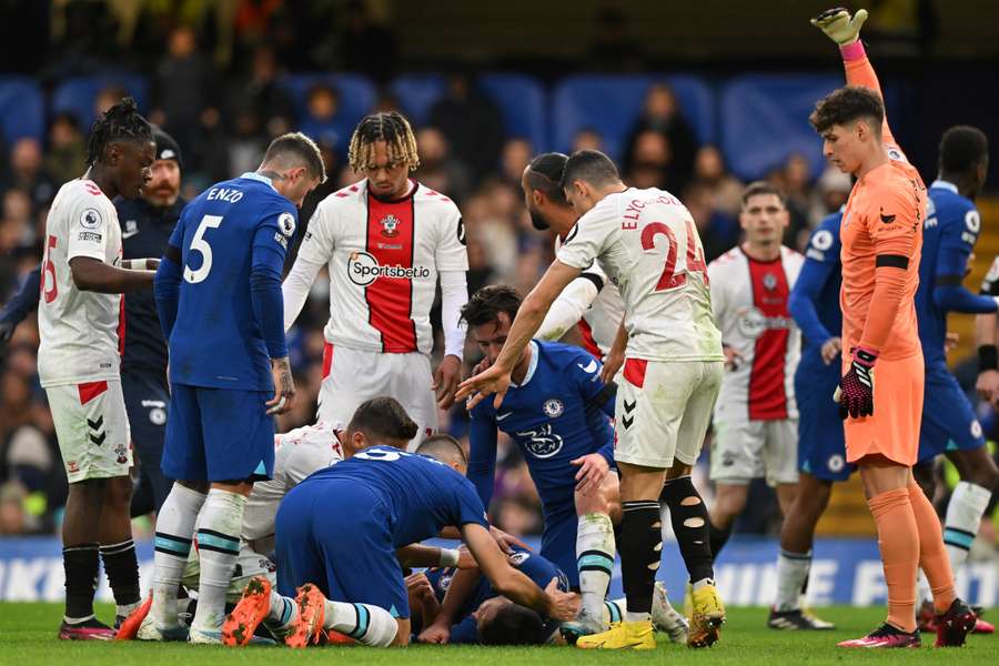 Players from both sides show concern for Cesar Azpilicueta, who was taken to hospital