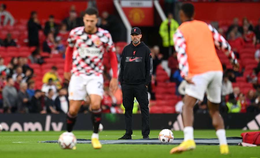 Jurgen Klopp, Manager of Liverpool watches the Manchester United warm up