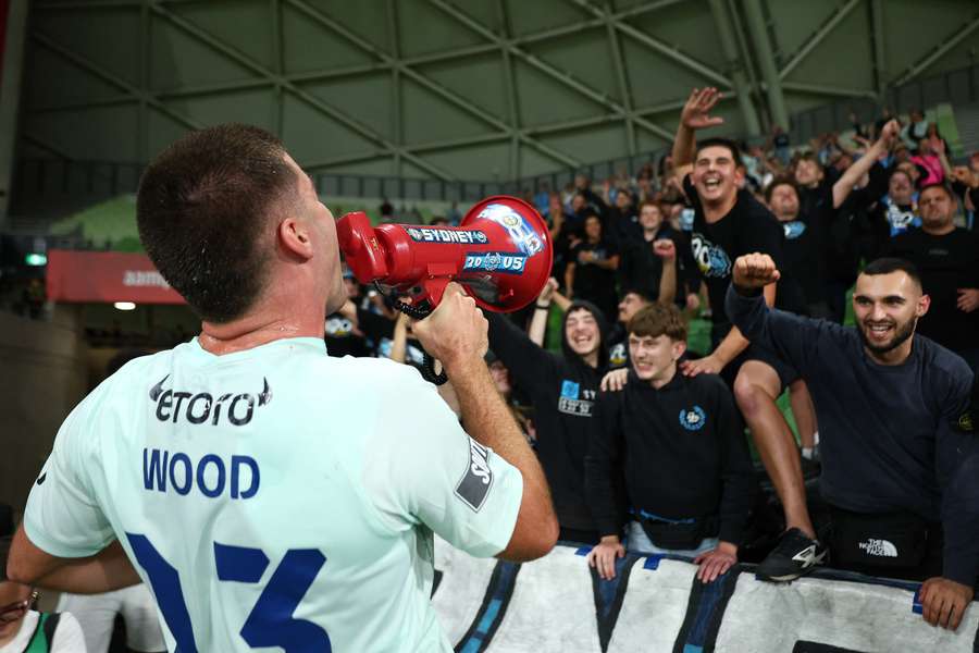 Sydney FC striker Pat Wood leads the post-game celebrations with the travelling Cove.
