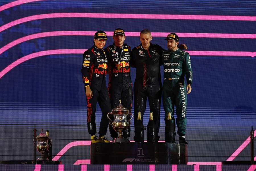 Max Verstappen celebrates on the podium with second placed Sergio Perez and third placed Fernando Alonso