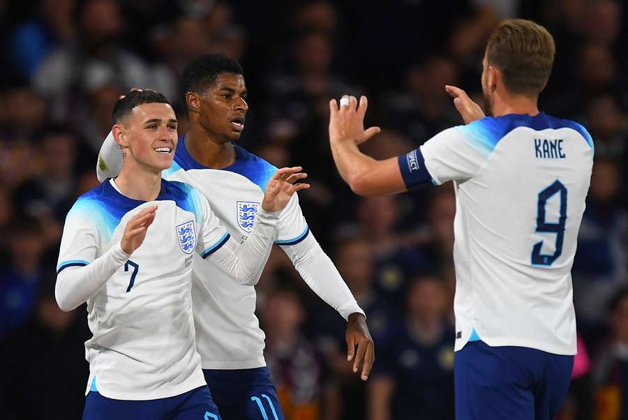 Phil Foden celebrates with Marcus Rashford and Harry Kane after scoring England's first goal