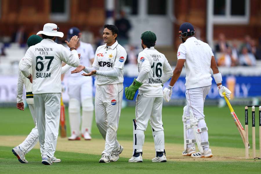Mohammad Abbas celebrates with teammates after taking the LBW wicket of England's Emilio Gay Mohammad Abbas celebrates with teammates after taking the LBW wicket of England's Emilio Gay
