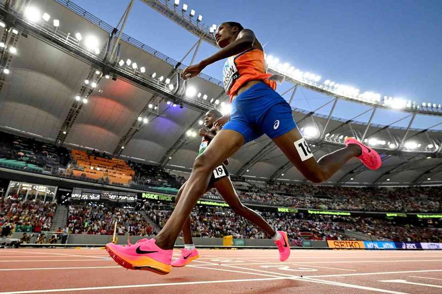 Sifan Hassan crosses the finish line ahead of Faith Kipyegon in the women's 5000m heats