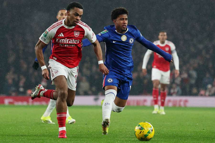 Arsenal defender Jurrien Timber (L) in action with Chelsea's Andrey Santos